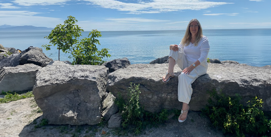 Linda Rose Cooper sitting in front of the water