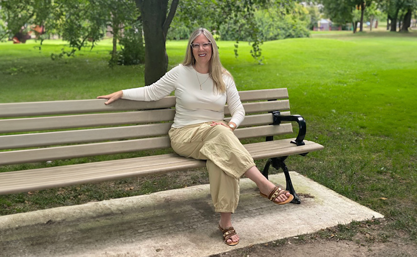 Linda Rose Cooper sitting on a bench in the park.
